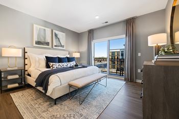 a bedroom with a bed and a sliding glass door at Stonehill at West Orange, West Orange, New Jersey